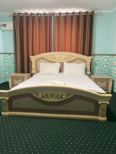 a bedroom with a large bed with white sheets at 7 Pir in Bukhara