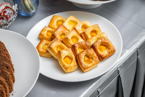 two waffles on a white plate on a counter at Elaf Qinwan Hotel in Makkah