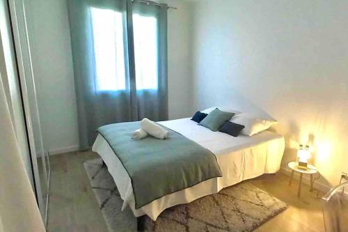 a bedroom with a large bed with a window at Bastia nid in Bastia