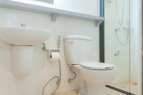 a bathroom with a toilet and a sink and a shower at Apo Hotel in Krabi town