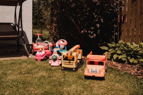 a group of toy vehicles sitting in the grass at Penzion Harmonia in Liptovský Mikuláš