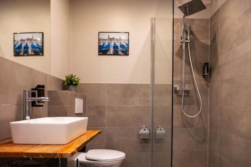a bathroom with a sink and a shower at Liro Hotel Viersen in Viersen