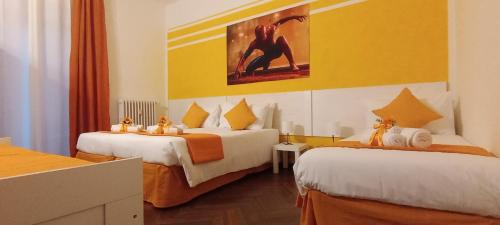 a hotel room with two beds and a painting on the wall at G&G Giusy e Gabry in Santhià
