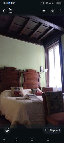 a bedroom with a large bed and a window at B&B Amarantha Gothica Genoa in Genova