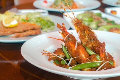 a plate of food with lobster on a table at Inya Lake Hotel Yangon in Yangon