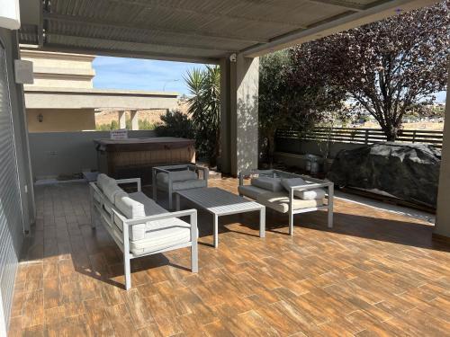 a patio with couches and tables and a piano at Vila los angels in Mitzpe Ramon