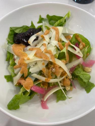 a white plate of food with a salad on it at Oh Activ Tarbes in Tarbes
