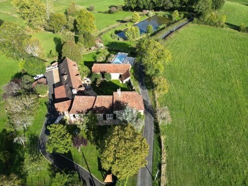 an aerial view of a house in a field at Demeure du Vallon - Chambres d'Hôtes de Charme in Azerat
