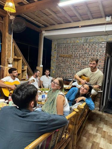 a group of people sitting at a table in a restaurant at Peaceful MaiChau Homestay in Mai Chau