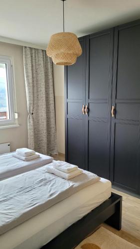 a bedroom with a large bed and a chandelier at Sunrise Apartment in Schladming