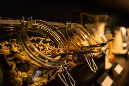a group of glass jars filled with food on a table at Seven Boutique Hotel in Ascona
