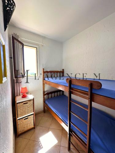 une chambre avec deux lits superposés et une fenêtre dans l'établissement Appartement Salduccio Piscine tennis mini golf LUMIO, à Lumio