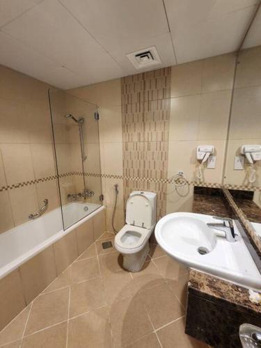 a bathroom with a toilet and a sink at Apartment in Al Barsha1 Near by Metro in Dubai