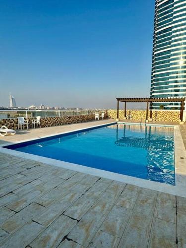 a large swimming pool on top of a building at Apartment in Al Barsha1 Near by Metro in Dubai