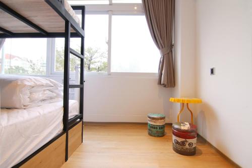 a bedroom with a bunk bed and a window at Taipei Sunny Hostel in Taipei