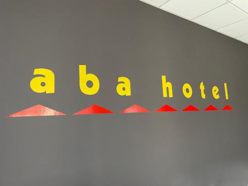 a sign for a hotel on a wall at Aba Hotel in Moncalieri