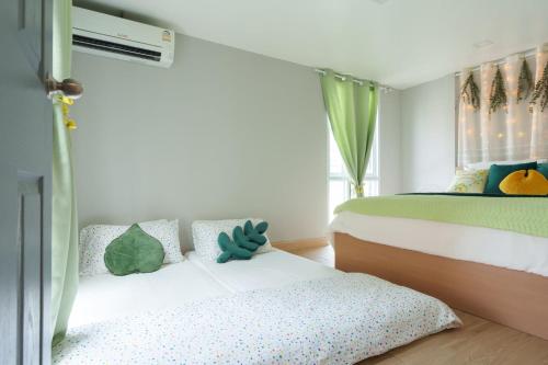 a bedroom with a bed with a teddy bear sitting on it at t-t-haus in Bangkok