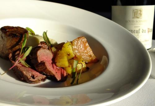 a white plate of food with meat and vegetables at Braid Hills Hotel in Edinburgh