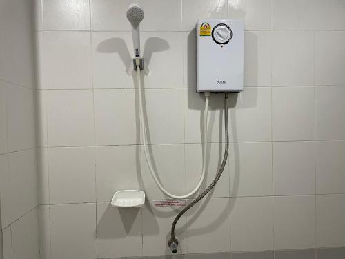 a shower in a bathroom with a blow dryer at Nawaporn Place in Phuket Town