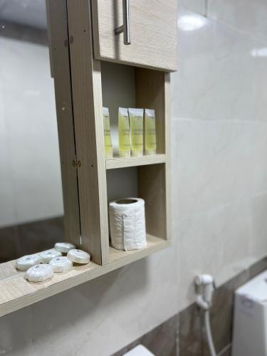 a cabinet with rolls of toilet paper in a bathroom at Bright Stars Camp in Disah