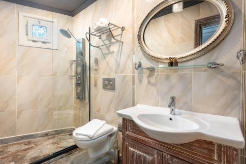 a bathroom with a sink and a toilet and a mirror at Wonder Wood Hotel in Istanbul