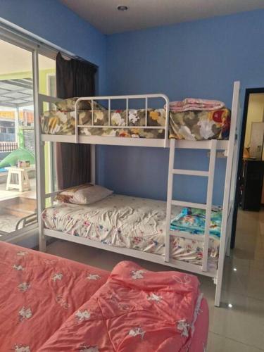two bunk beds in a room with a bed at ThawornSuk Pool Villa in Cha Am