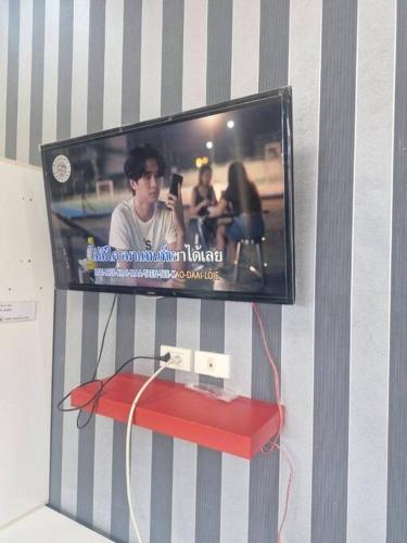 a flat screen tv hanging on a wall at ThawornSuk Pool Villa in Cha Am