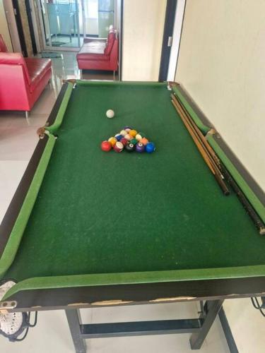 a pool table with balls on top of it at ThawornSuk Pool Villa in Cha Am