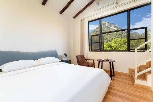 Voodi või voodid majutusasutuse Guilin Camphor Country House -Free pick up service toas