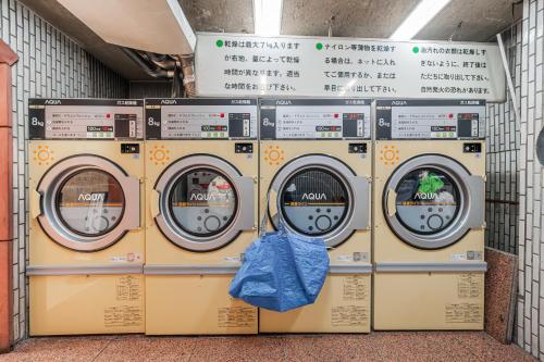 a row of washing machines in a laundrette at Kiwami Hotel Shinjuku in Tokyo