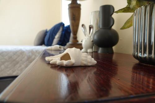 a wooden table with a toy animal on top of it at Tortugas Nest Resort in Miramar