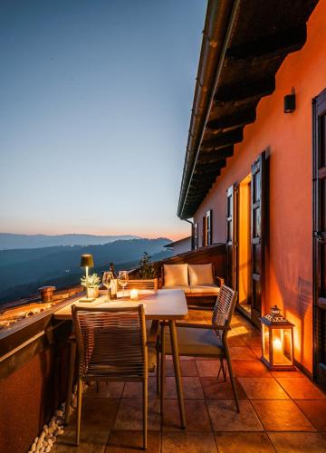 a patio with a table and chairs on a balcony at Green Hill Maranello, Vista e Relax in Montagnana