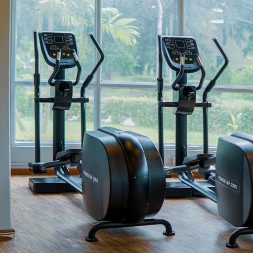 a row of exercise bikes in a room with a window at Inya Lake Hotel Yangon in Yangon