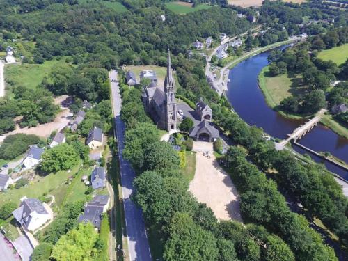 an aerial view of a church and a river at The nest in Spézet