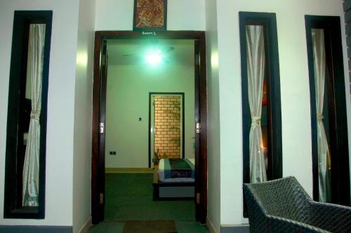 a hallway with a mirror in a room at Villa Rumah Putih Abu Abu in Senggigi 