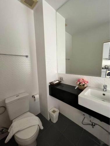 a bathroom with a white toilet and a sink at Chic condominium karon beach in Karon Beach