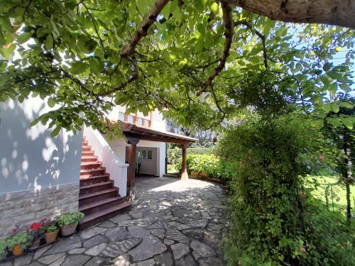 a house with a stairway leading to a building at Casa de vacaciones en Pedreña, Cantabria in Pedreña