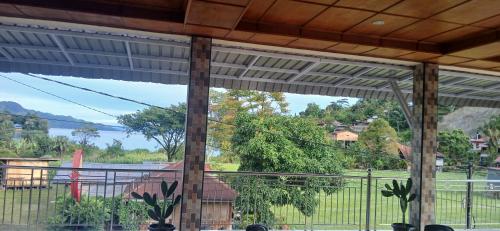 a screened in porch with a view of the water at Toba Boi in Tuk Tuk
