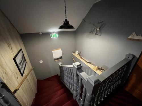 a staircase in a museum with a sign on the wall at Davids Kulle in Ronneby