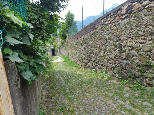 an alley in a stone wall at Zula House - Apartment Lake view in Bellano