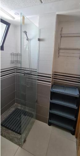 a bathroom with a shower and a glass door at Grayappart Kénitra in Kenitra