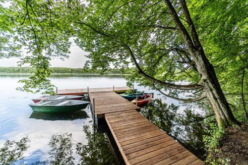 three boats are docked at a dock on a lake at Gulbity Camp in Gulbity