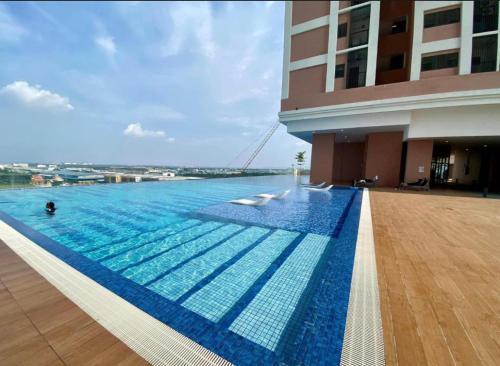 a large swimming pool next to a building at E-Zara Homestay in Shah Alam