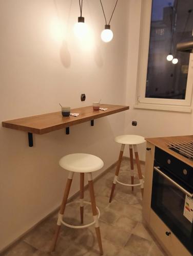a kitchen with two stools and a wooden counter top at My place in Sofia - Top center - 2 bedrooms - Self check-in in Sofia