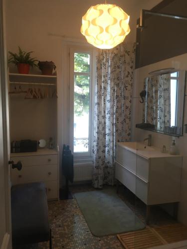 a bathroom with a sink and a mirror and a window at La Canopée in Bordeaux