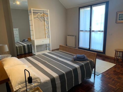 a bedroom with a large bed and a mirror at Villa Tobagi - Spacious house near Rho Fiera in Arese