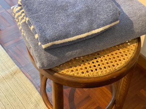 a chair with a blue blanket on top of it at Villa Tobagi - Spacious house near Rho Fiera in Arese