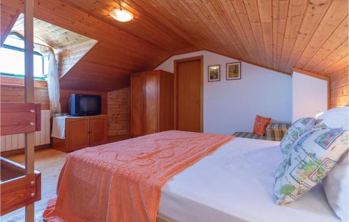 a bedroom with a bed and a tv in a room at Two-Bedroom Holiday Home In Tucepi in Tučepi