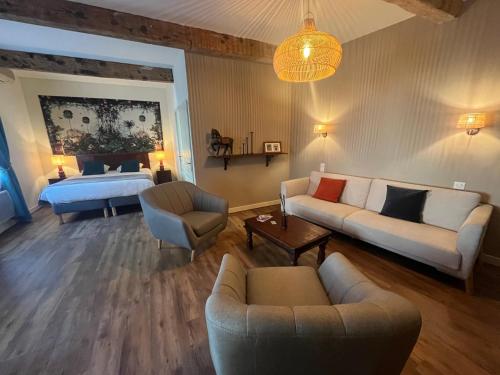a living room with a couch and a bed at Le Clos d'Orange - Hotel & ville de Provence in Orange