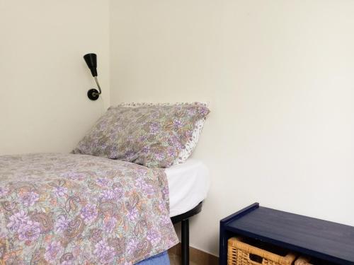 a bed with a pillow next to a wall at Casa Cairo Rooms&Services in Mombaroccio